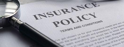 Magnifying glass with insurance policy documents